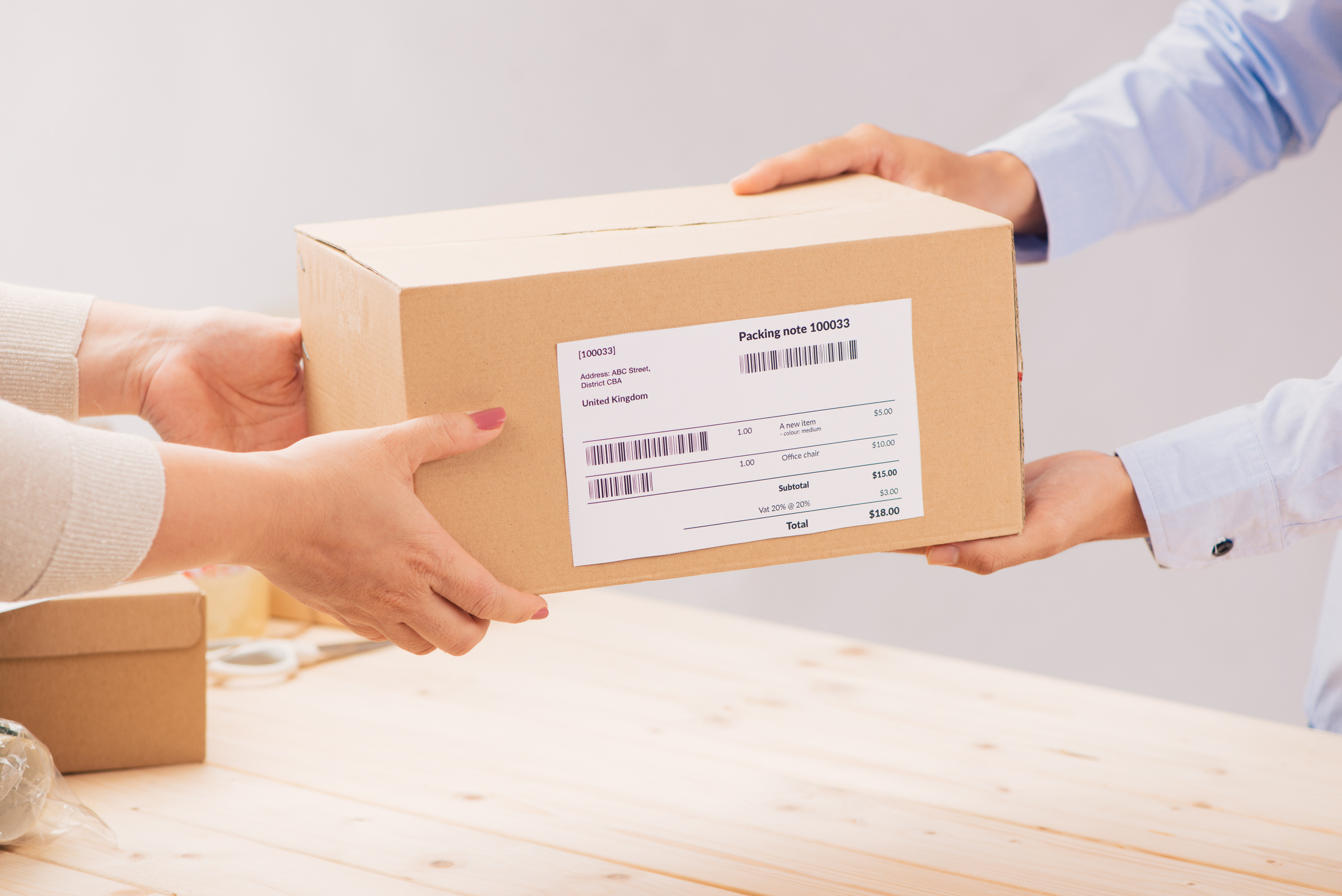 Woman gives parcel in post office